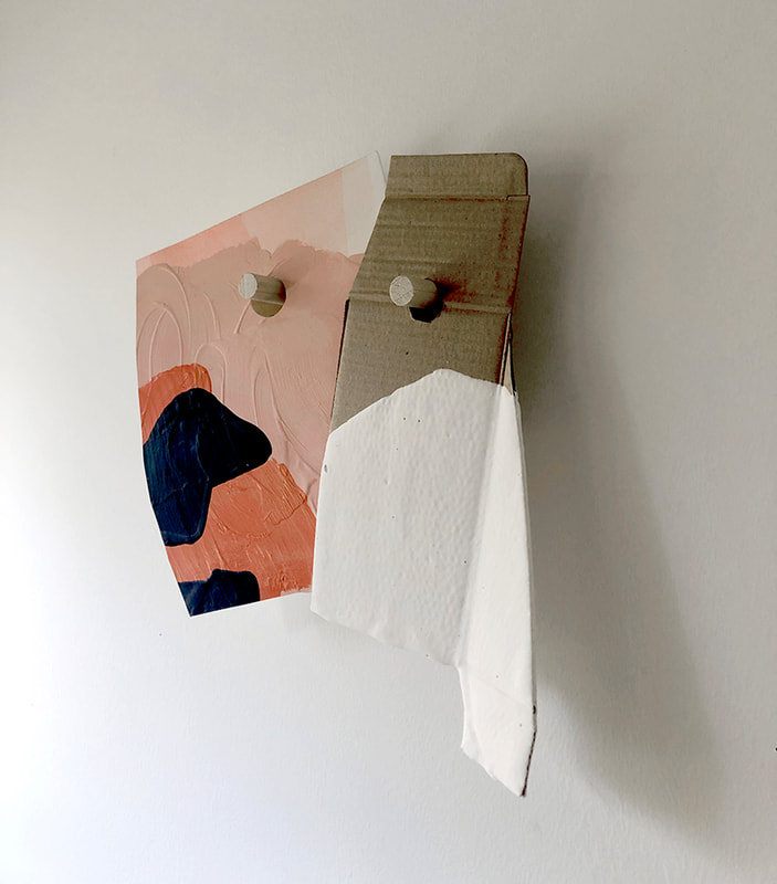 A two part peg drawing with white plaster dipped cardboard and a wider pink piece hanging from two half inch pegs with a single backing piece. 